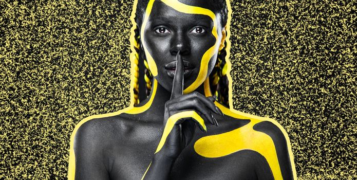 The Art Face. Modern design for music album coer. Contemporary art collage. Inspiration and idea for trendy magazines. Black and yellow body paint on african woman. Abstract creative portrait