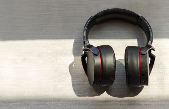 Big headphones for listening to music placed on white background. Personal device with Space for text. Selective focus.