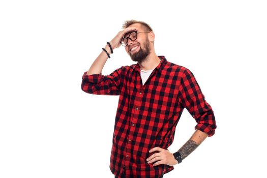 Handsome man model studio portrait. Boy casual style, trendy hipster in checkered shirt look with cool hairstyle. Studio shot on white background. Copy space