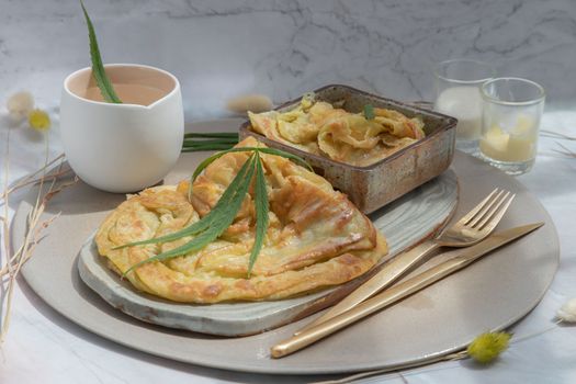 Homemade sweet frying roti (Cannabis Pancake) with Cannabis served with Cannabis tea on ceramic tray. Concept of food with cannabis herb, Treatment of medical marijuana for use in food, Selective focus.