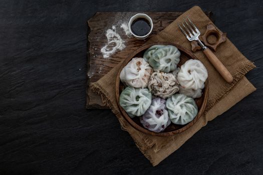 Chinese chives Dumplings Mixed Color or Garlic Chives Dim Sum Rice Cake inside with Taro Slice ,Bamboo shoot and Many kind of vegetable inside the flour, Steamed Served Sweet Black Soy Sauce Chinese Food Style side view, Chinese Food Appetizer dish Style, Top view.