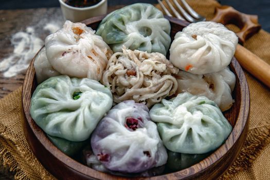Close-up of Chinese chives Dumplings Mixed Color or Garlic Chives Dim Sum Rice Cake inside with Taro Slice ,Bamboo shoot and Many kind of vegetable inside the flour, Steamed Served Sweet Black Soy Sauce Chinese Food Style side view, Chinese Food Appetizer dish Style.