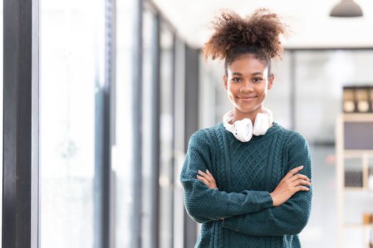 Portrait of smiling young black woman listening music with headset and digital tablet..