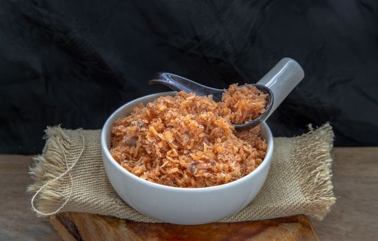 Shrimp paste with Dried shrimps in white Ceramic Bowl on brown gunny sack. Copy space, Selective focus. Copy space, Selective focus.