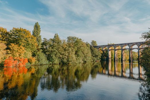 Railway Bridge with river in Bietigheim-Bissingen, Germany. Autumn. Railway viaduct over the Enz River, built in 1853 by Karl von Etzel on a sunny summer day. Bietigheim-Bissingen, Germany. Old viaduct in Bietigheim reflected in the river. Baden-Wurttemberg, Germany. Train passing a train bridge on a cloudy day in Germany