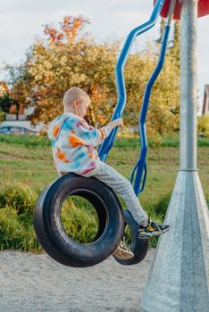 Funny cute happy baby playing on the playground. The emotion of happiness, fun, joy. Smile of a child. boy playing on the playground.