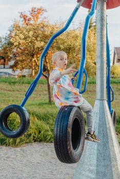 Funny cute happy baby playing on the playground. The emotion of happiness, fun, joy. Smile of a child. boy playing on the playground.