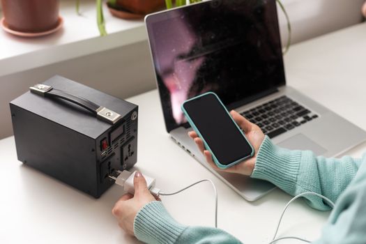 Charging station for phone, tablet, laptop and other gadgets when there is no light during blackout. Generator power bank battery in the absence of electricity. Charge electric rechargeable battery