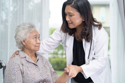 Doctor help and care Asian senior or elderly old lady woman patient sitting on wheelchair at nursing hospital ward, healthy strong medical concept