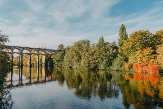 Railway Bridge with river in Bietigheim-Bissingen, Germany. Autumn. Railway viaduct over the Enz River, built in 1853 by Karl von Etzel on a sunny summer day. Bietigheim-Bissingen, Germany. Old viaduct in Bietigheim reflected in the river. Baden-Wurttemberg, Germany. Train passing a train bridge on a cloudy day in Germany