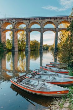 Railway Bridge with river in Bietigheim-Bissingen, Germany. Autumn. Railway viaduct over the Enz River, built in 1853 by Karl von Etzel on a sunny summer day. Bietigheim-Bissingen, Germany. Old viaduct in Bietigheim reflected in the river. Baden-Wurttemberg, Germany. Train passing a train bridge on a cloudy day in Germany