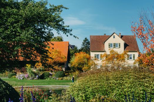 House with nice garden in fall. Flowers in the Park. Bietigheim-Bissingen. Germany, Europe. Autumn Park and house, nobody, bush and grenery