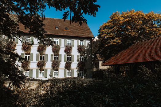 Old national German town house. Old Town is full of colorful and well preserved buildings. Baden-Wurttemberg is a state in southwest Germany bordering France and Switzerland. The Black Forest, known for its evergreen scenery and traditional villages, lies in the mountainous southwest. Stuttgart, the capital, is home to Wilhelma, a royal estate turned zoo and gardens. Porsche and Mercedes-Benz have headquarters and museums there. The 19th-century Hohenzollern Castle sits in the Swabian Alps to the south.