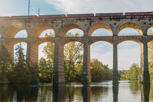 Railway Bridge with river in Bietigheim-Bissingen, Germany. Autumn. Railway viaduct over the Enz River, built in 1853 by Karl von Etzel on a sunny summer day. Bietigheim-Bissingen, Germany. Old viaduct in Bietigheim reflected in the river. Baden-Wurttemberg, Germany. Train passing a train bridge on a cloudy day in Germany