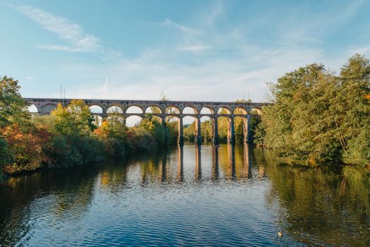 Railway Bridge with river in Bietigheim-Bissingen, Germany. Autumn. Railway viaduct over the Enz River, built in 1853 by Karl von Etzel on a sunny summer day. Bietigheim-Bissingen, Germany. Old viaduct in Bietigheim reflected in the river. Baden-Wurttemberg, Germany. Train passing a train bridge on a cloudy day in Germany