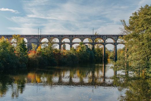 Railway Bridge with river in Bietigheim-Bissingen, Germany. Autumn. Railway viaduct over the Enz River, built in 1853 by Karl von Etzel on a sunny summer day. Bietigheim-Bissingen, Germany. Old viaduct in Bietigheim reflected in the river. Baden-Wurttemberg, Germany. Train passing a train bridge on a cloudy day in Germany