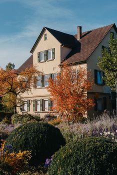 House with nice garden in fall. Flowers in the Park. Bietigheim-Bissingen. Germany, Europe. Autumn Park and house, nobody, bush and grenery