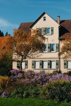 House with nice garden in fall. Flowers in the Park. Bietigheim-Bissingen. Germany, Europe. Autumn Park and house, nobody, bush and grenery