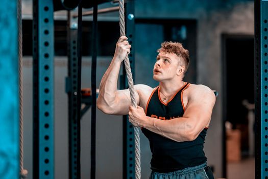 athlete with rope in gym. High quality photo