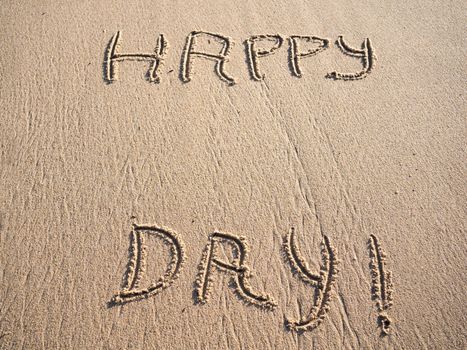 happy day words in sand with copy space.