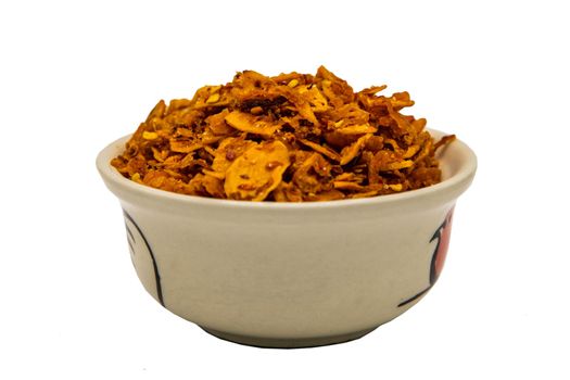 Dried chilli paste with crispy shrimp thai style or Crispy shrimp chilli paste in ceramic white cup isolated on white background with clipping path. Selective focus.