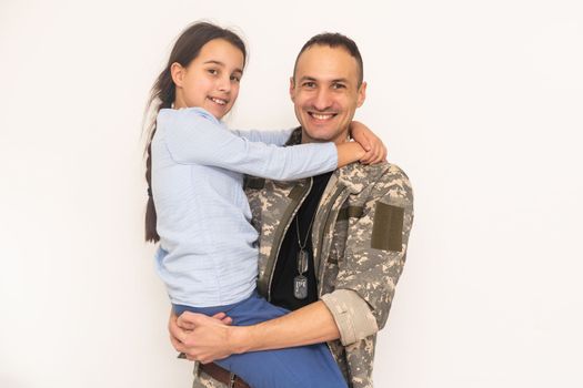 Affectionate girl looking at camera out of her father back in camouflage.