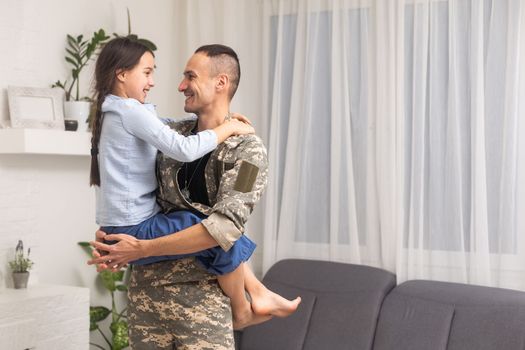 military father hugging his daughter