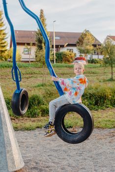 Funny cute happy baby playing on the playground. The emotion of happiness, fun, joy. Smile of a child. boy playing on the playground.