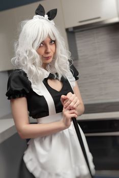 sexy girl in a governess costume for sexy adult games in the kitchen