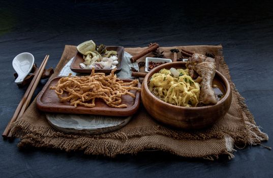 Northern Style Curried Noodle Soup with coconut milk (Khao soi), Traditional of Northern Thai cuisine, Oblique view from the top.