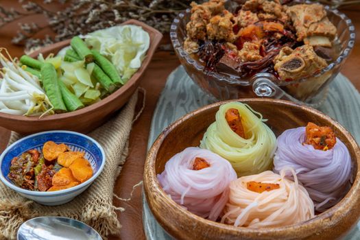 Rice noodles with spicy pork sauce or Nam ngiao Rice Noodle (Traditional Northern Thai Cuisine). Nam ngiao has a characteristic spicy and tangy flavor Served with vegetable. Thai spicy food.