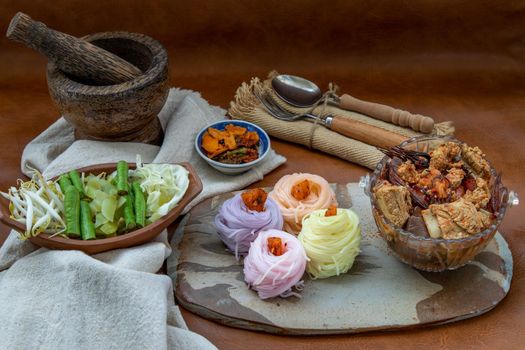 Rice noodles with spicy pork sauce or Nam ngiao Rice Noodle (Traditional Northern Thai Cuisine). Nam ngiao has a characteristic spicy and tangy flavor Served with vegetable. Thai spicy food.