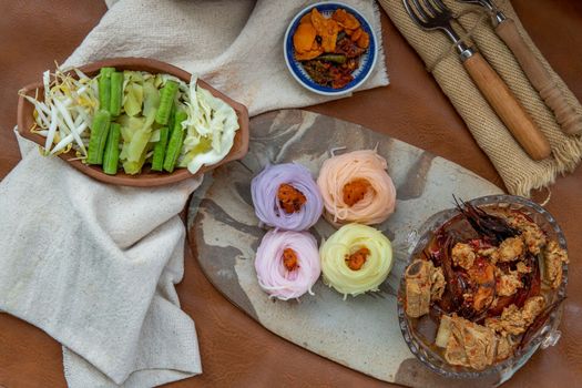 Rice noodles with spicy pork sauce or Nam ngiao Rice Noodle (Traditional Northern Thai Cuisine). Nam ngiao has a characteristic spicy and tangy flavor Served with vegetable. Thai spicy food.