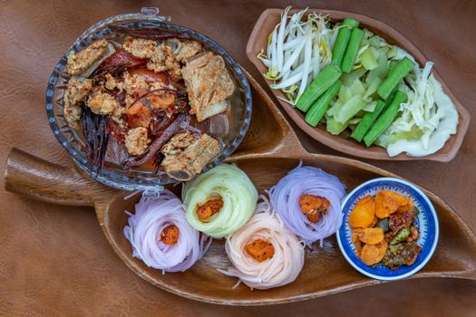 Rice noodles with spicy pork sauce or Nam ngiao Rice Noodle (Traditional Northern Thai Cuisine). Nam ngiao has a characteristic spicy and tangy flavor Served with vegetable. Thai spicy food.