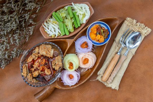 Rice noodles with spicy pork sauce or Nam ngiao Rice Noodle (Traditional Northern Thai Cuisine). Nam ngiao has a characteristic spicy and tangy flavor Served with vegetable. Thai spicy food.