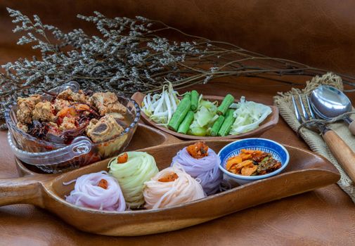 Rice noodles with spicy pork sauce or Nam ngiao Rice Noodle (Traditional Northern Thai Cuisine). Nam ngiao has a characteristic spicy and tangy flavor Served with vegetable. Thai spicy food.