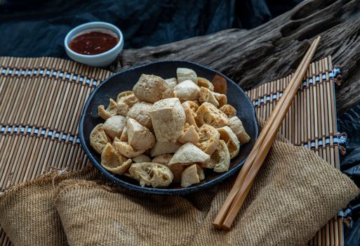 Deep fried crispy tofu or Fried bean curd Served with Sweet and Sour spicy sauce. Selective focus.