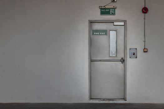 Fire exit door for emergency case with alarm for safety protection of the car parking  building near the Condominium building. Safety first concept, Copy space, Selective focus.