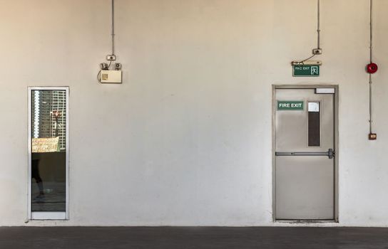 Fire exit door for emergency case with alarm for safety protection of the car parking  building near the Condominium building. Safety first concept, Copy space, Selective focus.