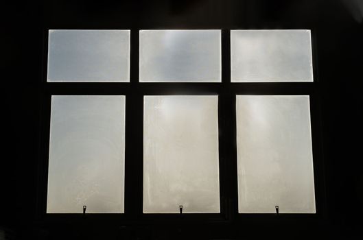 Large glass windows silhouettes frame on black background. Copy space, Selective focus.