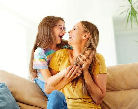 mother and daughter playing and having fun at home