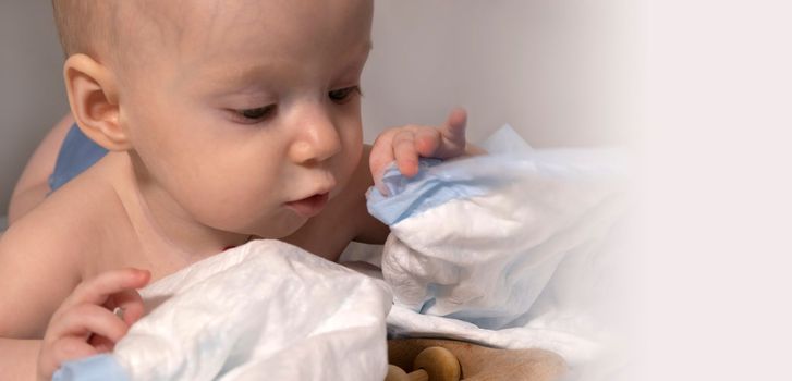 a baby with a hemangioma on his neck lies on a white background. banner with a copy space. profile of a little bald baby girl. the kid looks to the side