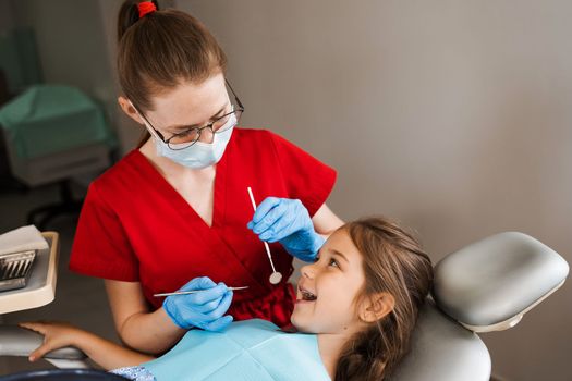 Cheerful child girl smiling at dentists consultation in dentistry. Dental diseases. Consultation with pediatric dentist for treatment of toothache in child