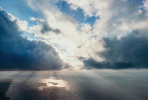 Blue sky with white clouds over calm summer panorama of the sea. Drone aerial view. Abstract aerial nature summer ocean sunset sea and sky background. Horizon. No people. Holiday and vacation concept