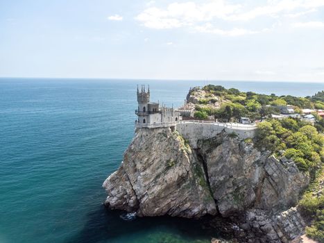 Aerial view of Swallow's Nest castle on the rock in Black Sea. It is a symbol and landmark of Crimea. Beautiful scenic panorama of the Crimea coast. Amazing Swallow's Nest at the precipice.