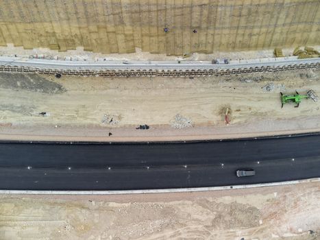 Aerial drone shot Road construction in progress in wild nature canyon.