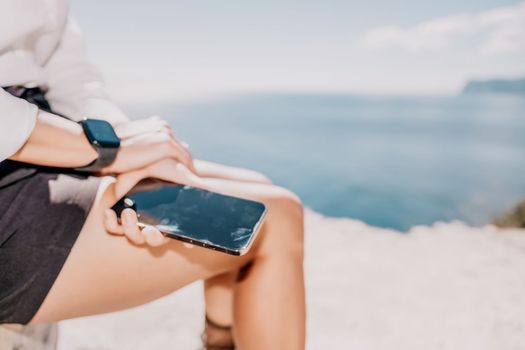 Happy girl doing yoga with laptop working at the beach. beautiful and calm business woman sitting with a laptop in a summer cafe in the lotus position meditating and relaxing. freelance girl remote work beach paradise