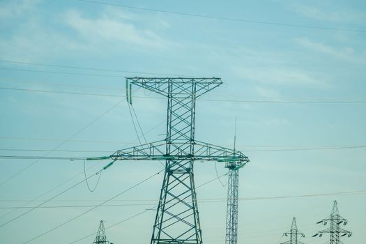Silhouette High voltage electric tower on sunset time, distribution electric substation with power lines and transformers.