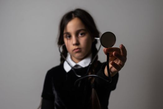 Wednesday student girl with a stethoscope.