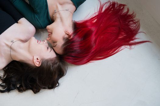 Top view of two women lying side by side. Lesbian intimacy